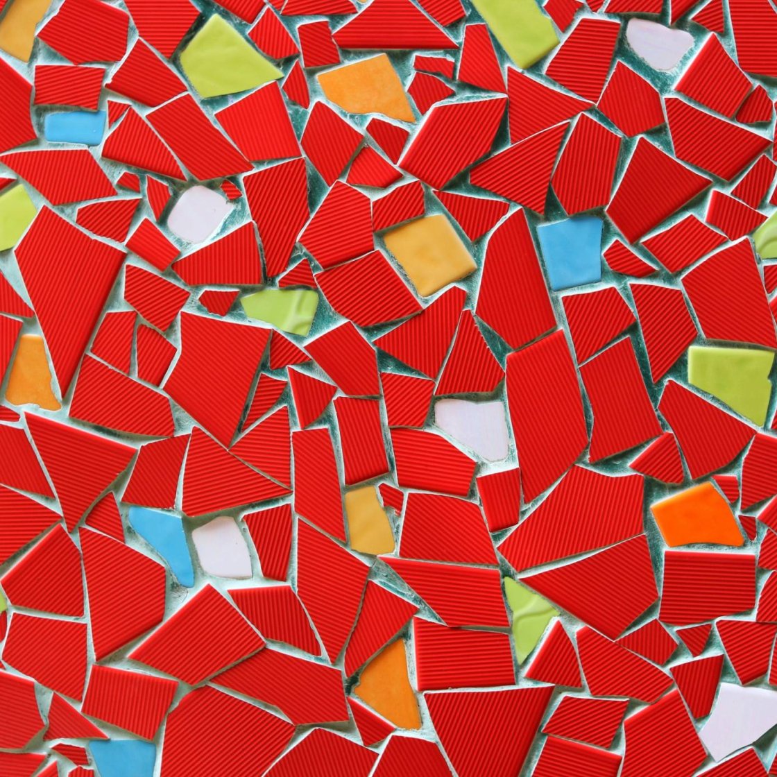 A bright mosaic with red and multi-cololred tiles