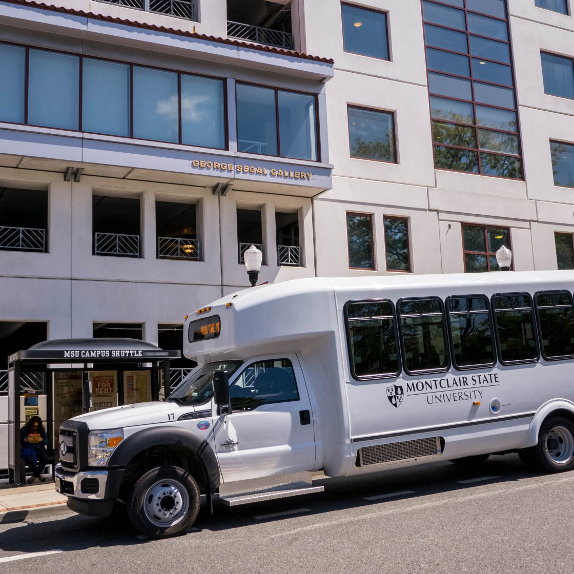 University shuttle bus parked outside Red Hawk Deck.