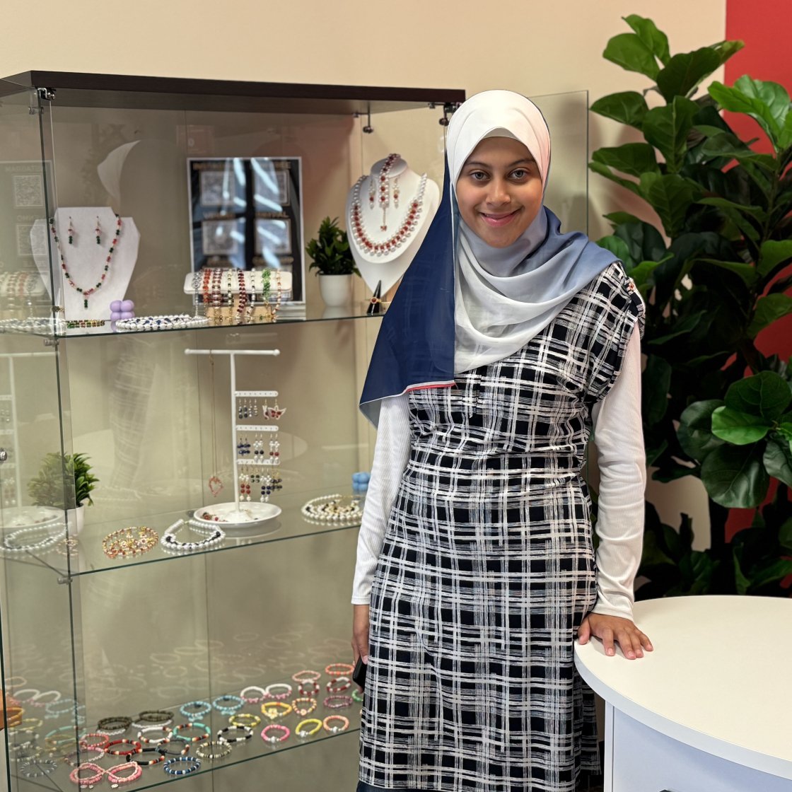 A student vendor proudly showcases her display at Creators' Corner