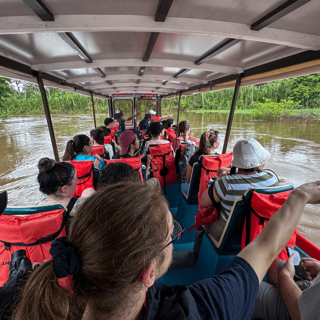 Students in a canoe and red life vests.