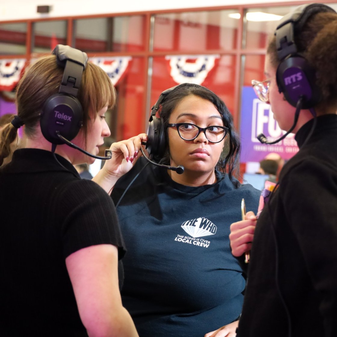 Crew members conversing during production.