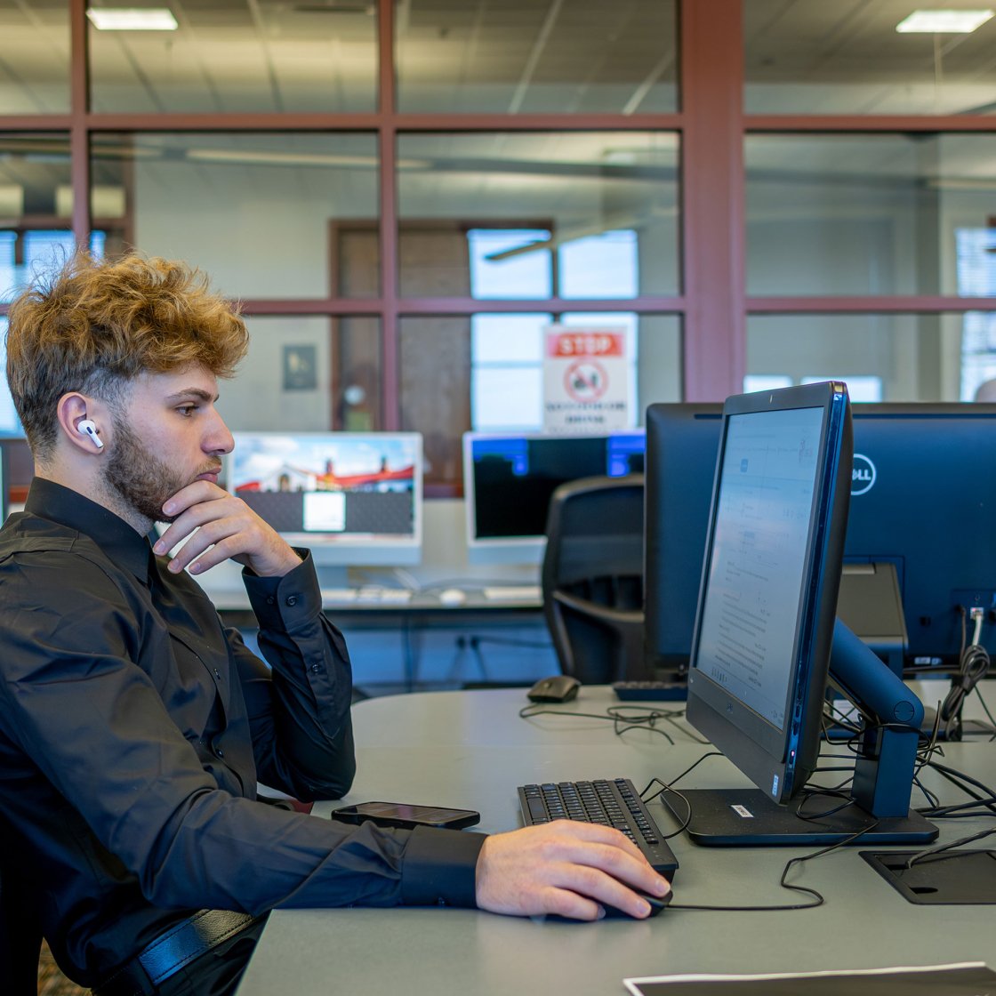 Student working on a computer in the computer lab.