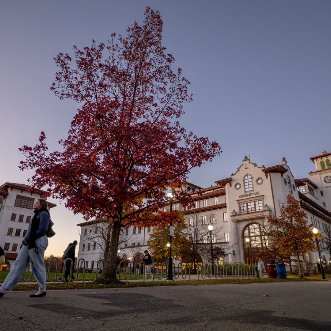 university hall with people walking at dusk