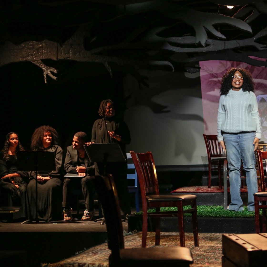 actor on stage with ensemble