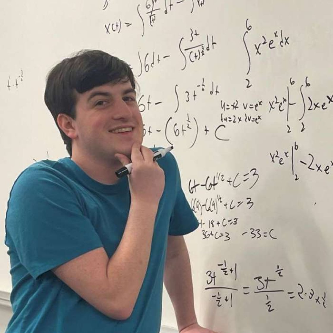 Ryan Avallone by whiteboard with math formulas