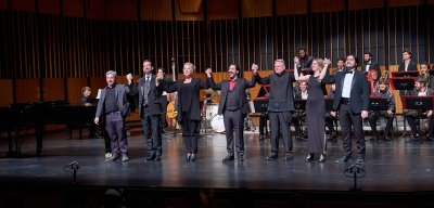 Cali Faculty on stage of Kasser Theater holding hands