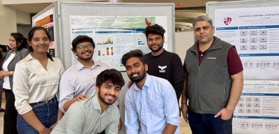 students and mentor with poster at capstone student showcase