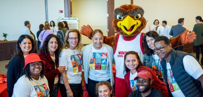 group pf people posing with Rocky the Mascot