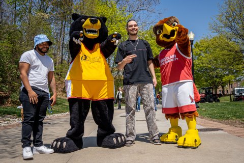 Two men are posing with the mascot of Bloomfield College and Montclair State University.