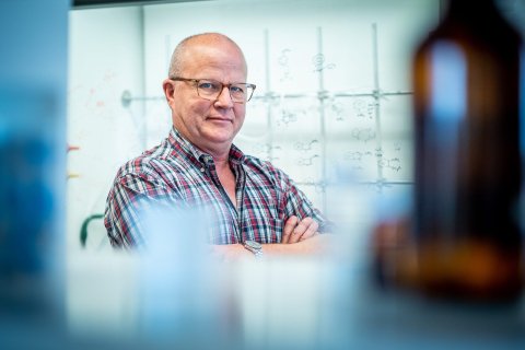 Man with his arms crossed with glasses on.
