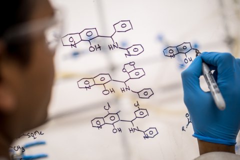 Scientist drawing up a molecular structure.