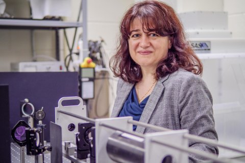 Rodica Martin standing by equipment in Physics lab