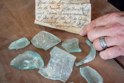 Letter from a glass bottle broken open.