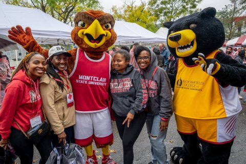 Mascots, Rocky and Deacon, taking a picture with students.