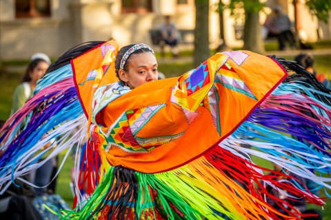 Native American dancer in colorful traditional regalia