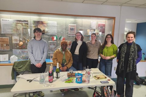 students standing in from of cookbook display