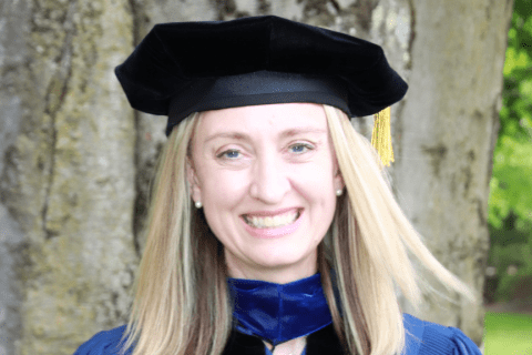 Photo of Alexandra Thelin Blackowski in graduation robe from Drew University