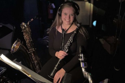 Maria Vincelette with clarinet in orchestra pit