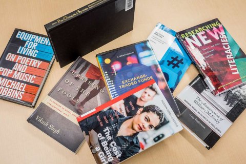 Pile of books written by faculty and staff authors