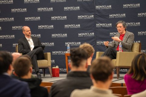 Jack Hanlon on stage being interviewed by Michael Hacker
