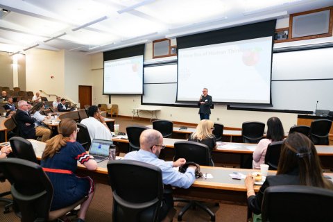 man presenting powerpoint to audience