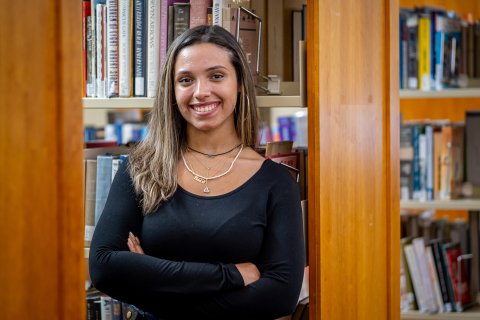 Student smiling in library