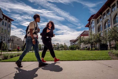 two students walking on campus together 