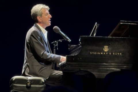 Jason Robert Brown playing the piano on the stage at Kasser Theater