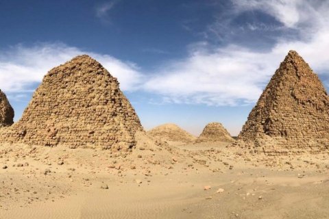 Four stone pyramids of different sizes stand at the Royal Cemetery of Nuri in Sudan