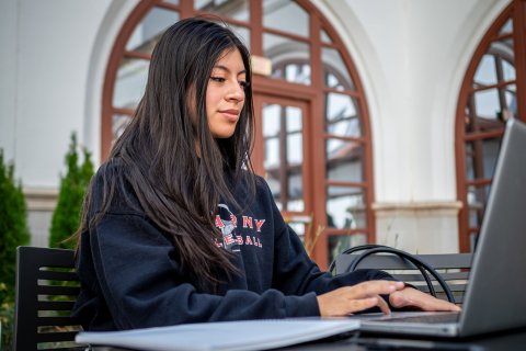 a student works at her laptop