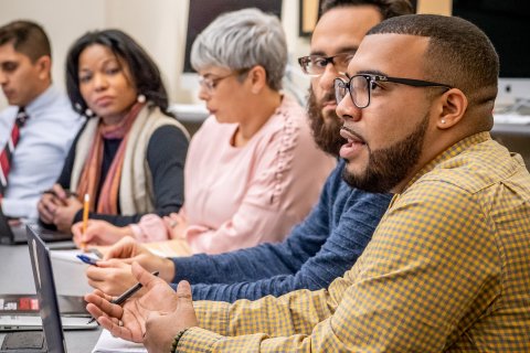 a group of students has a discussion
