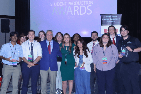 Students and professors pose on stage at the CBI Awards.
