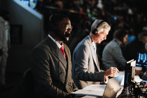 Side view of Edmond commentating his first NBA game.