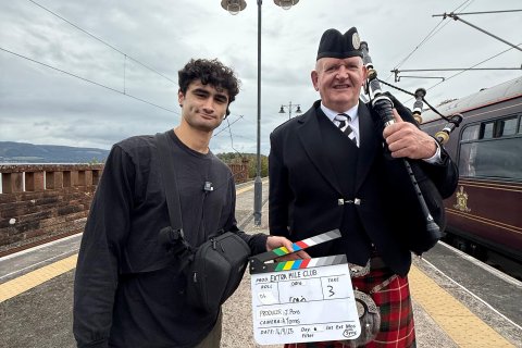 CCOM Alum on set posing with an actor.