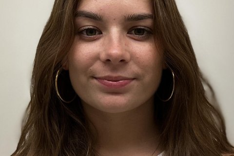 Student headshot against white wall.