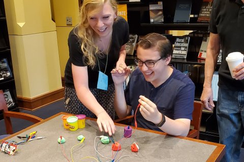 two students use technology in a workshop