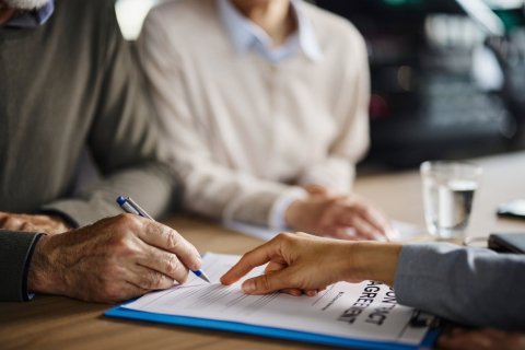 Image of perrson signing an agreement