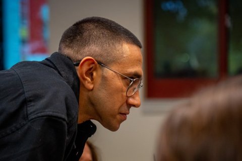 A side view of a man leaning forward