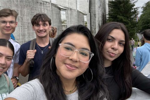 A group of five college students take a selfie outside a castle in Munich, Germany