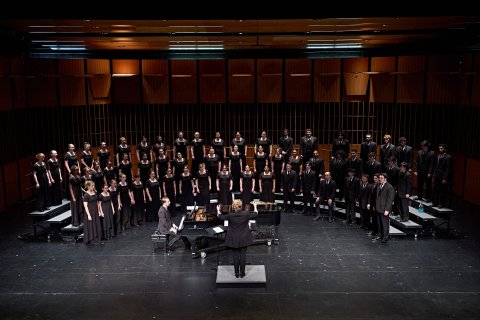 Choir on stage with director