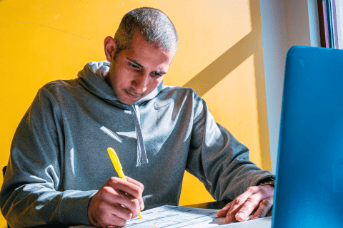 Student writes in a notebook.