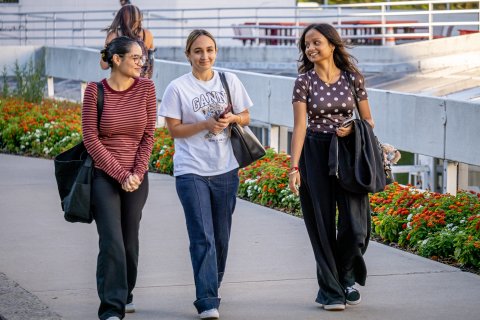 three students walking on campus