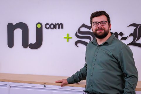 Student headshot of CCOM alum Sal DiMaggio in front of the NJ.com sign.