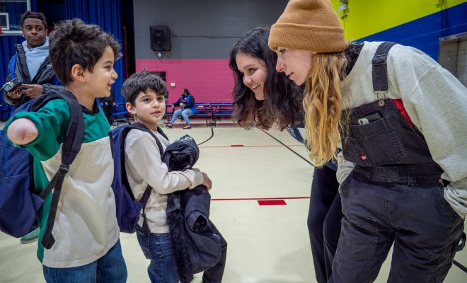 Two Montclair State University AmeriCorps members, Sophia Civitella and Ema Halilovic, play with two children at the Paterson Boys and Girls Club during the University’s 9/11 Day of Service. (Photo by John J. LaRosa)