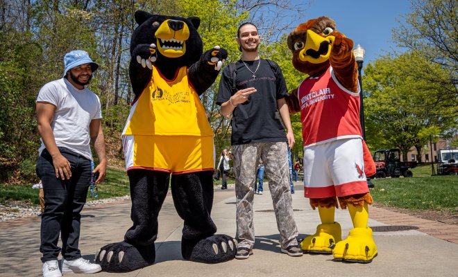 Two men are posing with the mascot of Bloomfield College and Montclair State University.
