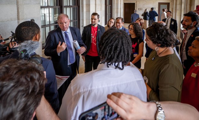 A state senator talks to a group of students, faculty and staff.