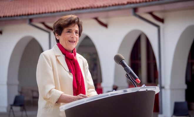 Photo of Montclair State University President Susan A. Cole at a lectern