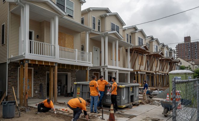 Montclair State University volunteers work together on a Habitat for Humanity home construction site in Paterson, NJ, as part of the 9/11 Day of Service and Remembrance.