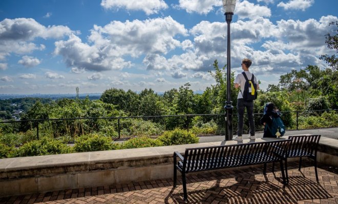 Students on campus looking at the NYC skyline.