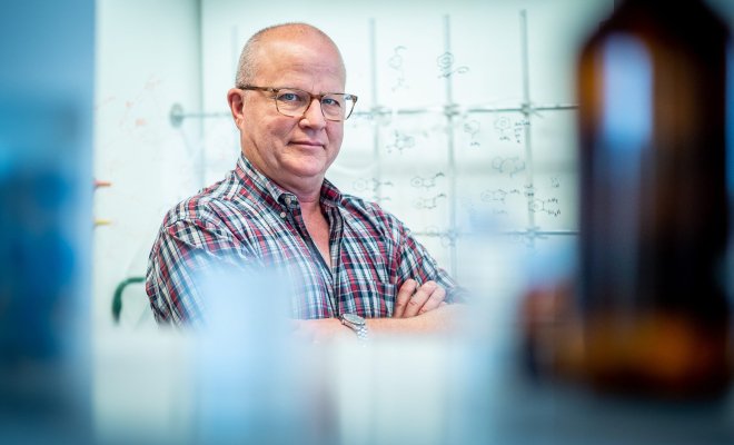 Man with his arms crossed with glasses on.